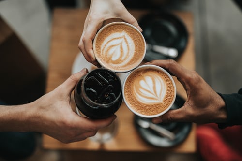 three_person_holding_coffee_cups.jpeg